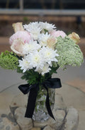 Bouquet of flowers with a black ribbon in a glass vase