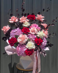 Hat box arrangement of roses and hydrangeas 